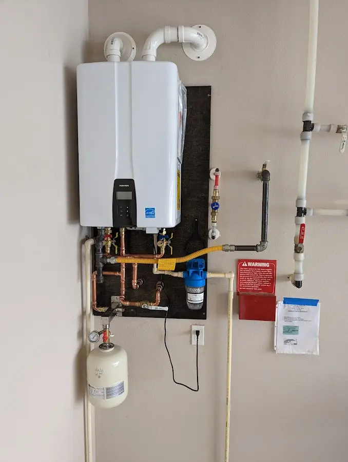 Professional plumber installing copper piping in a Savoy home